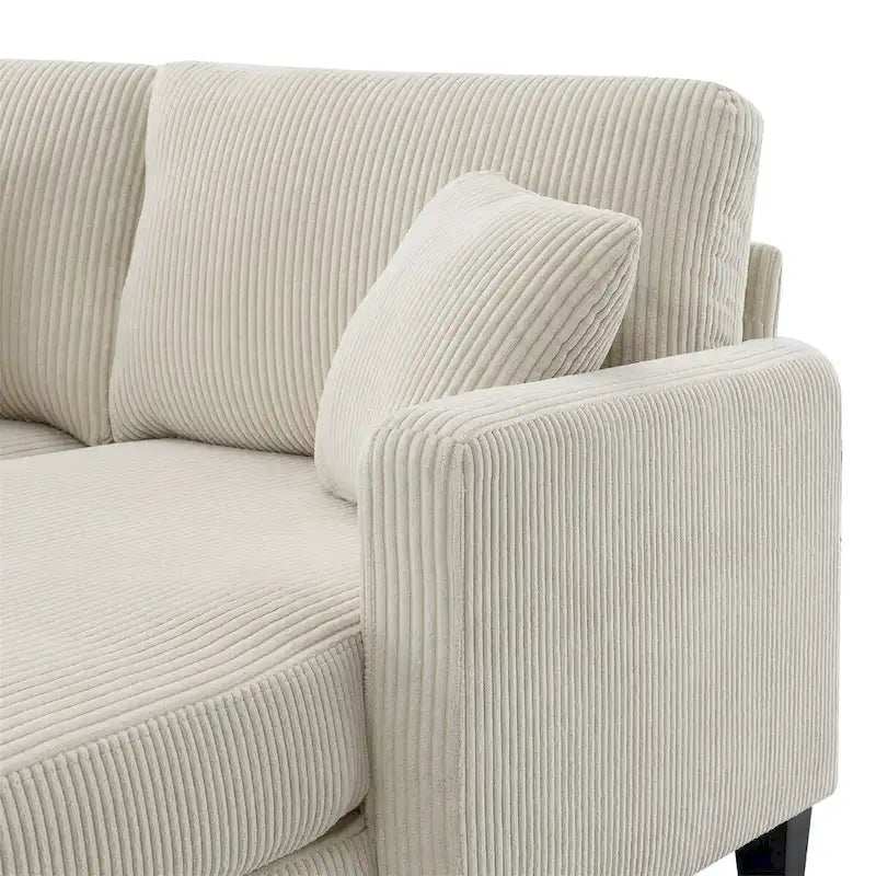 Un canapé d'angle moderne en velours côtelé avec une méridienne dépliable.